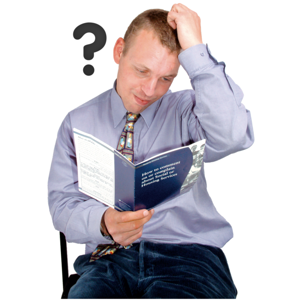 A man reading a pamphlet and looking confused